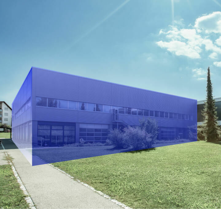 Modern office building with a transparent blue digital overlay highlighting its structure under a sunny sky.